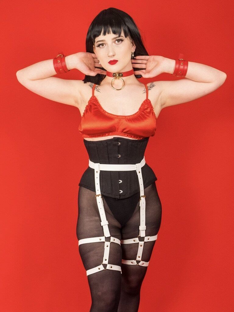 Female model wearing our Cherry Red Tatum Satin Bralette and Briefs with our Marshmallow White Zoe Leg Harness.